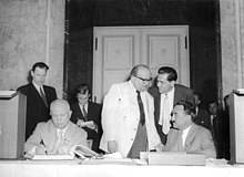Nikita Khrushchev with Anastas Mikoyan (far right) in Berlin Bundesarchiv Bild 183-49000-0329, Berlin, Chruschtschow tragt sich ins Goldene Buch ein.jpg