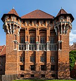 Front view of a castle tower in red brick