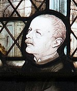 Portrait of a man with moustache and wing collar on stained glass window