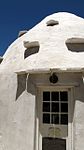 Circular stone corbelled building, with adjacent flat-roofed extension. Roughly plastered and whitewashed. Far to the north of Beaufort West stretch the hard, parched plains of Williston and Canarvon. On many farms in that area corbelled houses or so-called klip rondawels may still be seen. These dwellings are interesting examples of the ingenuity of the earli Type of site: Corbelled House Previous use: Dwelling. Current use: Store. 19,5 km from turn-off, along gravel road.. This corbelled house is an example of the ingenuity of the earliest white inhabitants in this area and are important relics of the cultural and national architectural history in South Africa.