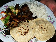 Pork ribs with corn tortillas, rice, and salad