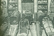 Photograph of some of the coffins and mummies found in DB320. Taken before the mummies were unwrapped by Maspero. DB320 Mummies 1881.jpg