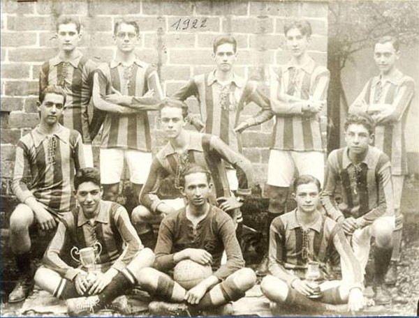 The 1922 amateur squad proudly showcasing the coveted national cups earned in 1918 and 1920