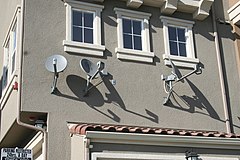 Satellite dishes installed on an apartment complex.