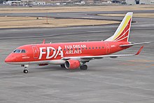 A Fuji Dream Airlines Embraer E170 in red livery at Nagoya Airfield