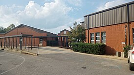 Image of the main entrance to Isabella High School. Pictured is a breezeway connecting two academic buildings. The front facade of the breezeway displays "Isabella" and bears a coat of arms.