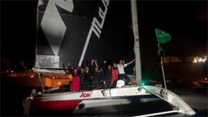 Elkann, Giovanni Soldini, and the Maserati Multi V70 at the finish line of the 2020 Rolex Middle Sea Race