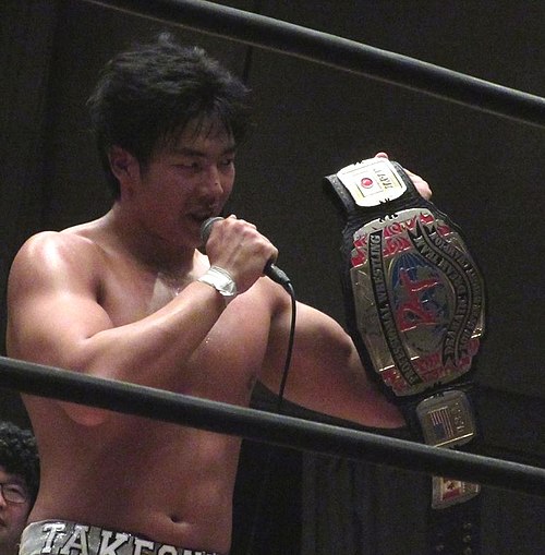 Takeshita holding the KO-D Openweight Championship belt in May 2016