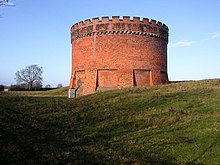 The crenelated top of one of the ventilation shafts of the Kilsby Tunnel, visible from the A5 road Kilsby Tunnel Airshaft - geograph.org.uk - 1607032.jpg