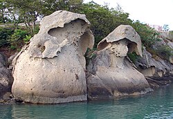 Tafoni formations, named Gatbawi (Hat Rock), found on the shore of Mokpo's east harbor, near the mouth of the Yeongsan River, South Jeolla Province, South Korea.