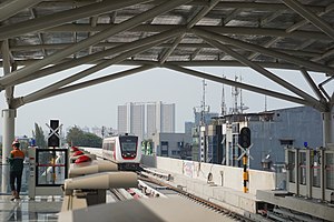 LRT Jakarta - Hyundai Rotem LRV Leaving Velodrome Station.jpg