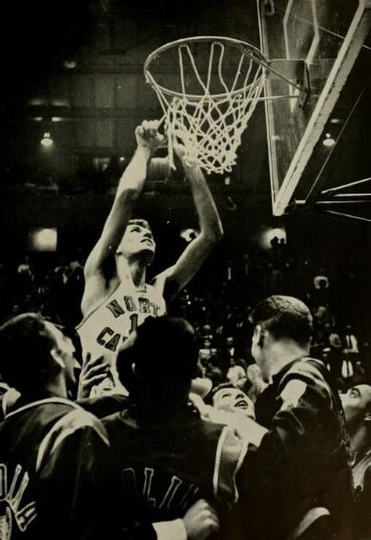 The Tar Heels' Lennie Rosenbluth cuts down the nets after winning the 1957 title.