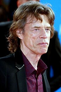 Rolling Stones frontman Mick Jagger (pictured in 2014) teamed up with David Bowie for a cover version of Martha and the Vandellas' "Dancing in the Street", which topped the chart in September 1985 for four weeks. Mick Jagger Deauville 2014.jpg