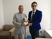 Noble Laureate Prof Yunus with Dr. Edmond, CEO, CHD Group Noble Laureate Prof Muhammad Yunus receiving the book by Dr Edmond Fernandes.jpg