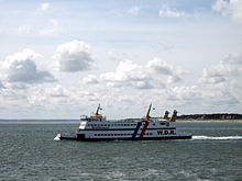 A car and passenger ferry leaving Föhr.