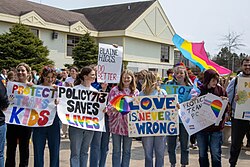 Students holding signs at a rally at the Quispamsis Town Hall Policy 713 Walkout Signs.jpg