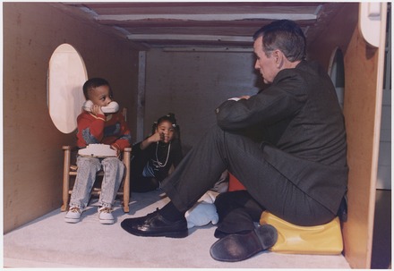 President George H. W. Bush plays with children in a jungle gym at the Emily Harris Head Start Center in Catonsville, 1992.