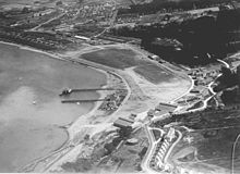 Aerial view of Crissy Field 1922-23, hangars and quarters in lower center. The H-shaped building at right center is the enlisted barracks. Prsf crissy arial 1921.jpg