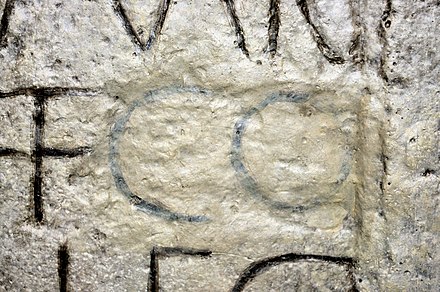 Damnatio memoriae of Commodus on an inscription in the Museum of Roman History in Osterburken, Germany. The abbreviation "CO" has been restored with paint.