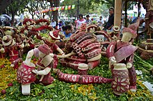 "Arte y Cultura de Oaxaca" by Jose Maria Ramirez Vasquez at the 2014 Noche de Rabanos. The display shows artisans creating barro negro pottery. Rabanos2014 080.JPG