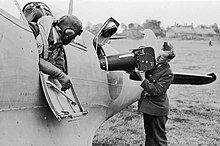 A Type F.8 Mark II (20-inch lens) aerial camera being loaded into a Supermarine Spitfire PR Mk IV at RAF Benson during the Second World War