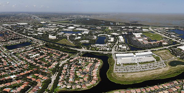 Panoramic aerial view of Sawgrass Corporate Parkway in Sunrise, showing the American Express offices. The Everglades and Weston are also shown in the 