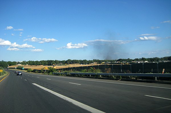 The Long Island Expressway at Exit 49S, the site of the future Canon USA headquarters; smoke from a fire in Farmingdale is visible in the near backgro