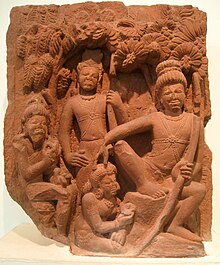 A brown stone sculpture. Rama sits on a stone under a tree (right, largest figure) with a bow in left hand and the other hand on the head of Ahaya(centre bottom), who is seated on the ground with flowers in her hand. Behind her stands Lakshamana. The leftmost figure is of Vishvamitra sitting on a stone.