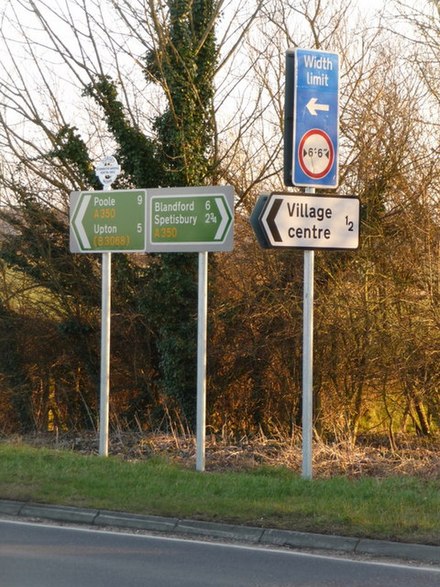 Fingerposts and other road signage in the English village of Sturminster Marshall, near Poole