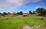Svartlöga by ligger vid en vik på den sydöstra delen av ön. Det som nu är en äng har tidigare varit den inre delen av byhamnen.
