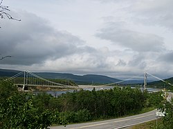 View of the old bridge that spanned the river Tanaelva. A new bridge has replaced it. The river banks on the right side of the photo, are part of the Varanger Peninsula.