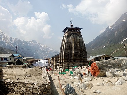 Rear view of the Kedarnath Temple in the aftermath of the flood with the huge rock that protected the temple.