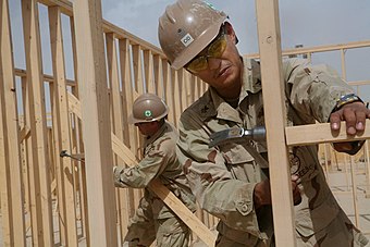 Two U.S. Navy Seabees who are Filipinos framing walls at Camp Leatherneck in Afghanistan