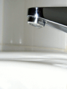 B. Water dripping from a tap