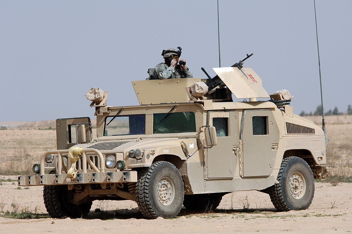 A left front view of a U.S. Army M998 High-Mobility Multipurpose Wheeled  Vehicle (HMMWV) equipped with an M220A1 tube-launched, optically-tracked,  wire-guided (TOW) missile launcher during testing - PICRYL - Public Domain  Media