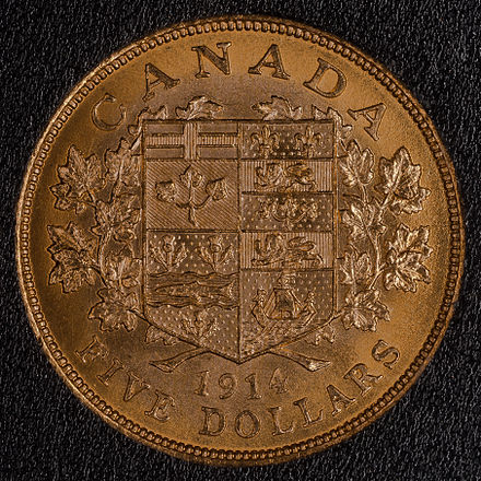 $5 gold Canadian coin from 1914. Reverse side shown depicting a shield with the arms of the Dominion of Canada. The coin weighs 8.36 g and is 90% gold giving it 7.524 g of gold. It has a diameter of 21.59 mm and a thickness of 1.82 mm at the rim.
