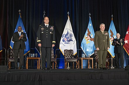U.S. Secretary of Defense Lloyd Austin (extreme left), incoming combatant commander Michael Kurilla (center) and outgoing commander Kenneth F. McKenzie Jr. (right) and Chairman of the Joint Chiefs of Staff Mark A. Milley (extreme right) at the USCENTCOM change of command ceremony on 1 April 2022.