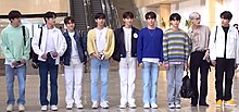 The image features nine people in their casual attires at Gimpo International Airport.