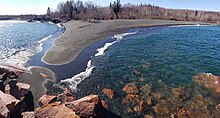 Black beach, named for the darkly-colored taconite tailings in the its sand, is now a popular tourist attraction Black Beach Silver Bay.jpg