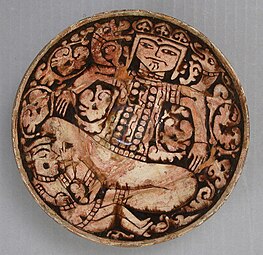 Bowl depicting King Zahhak with snakes protruding from his shoulders, 12th–13th century, with alterations first half 20th century. Attributed to Northwestern Iran, Garrus District. Metropolitan Museum of Art.[7]
