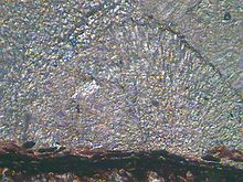 Algunes làmines en forma de teranyina que s'encavalquen unes sobre les altres en un lloc; en d'altres, l'encavalcament és menor. La secció de la bola de carbó sembla un vidre trencat. Hom pot veure-hi una línia gruixuda i fosca.