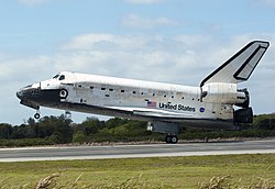 Concluding the STS-133 mission, Space Shuttle Discovery touches down at the Shuttle Landing Facility - cropped