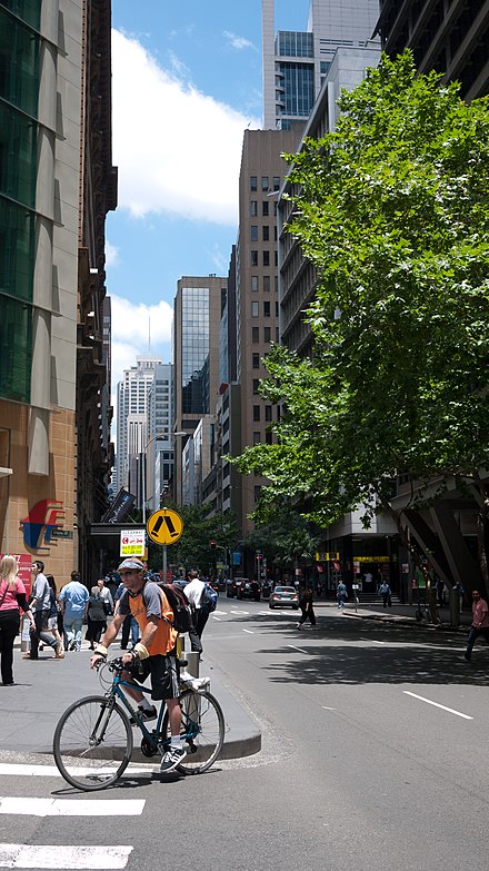 A cyclist and pedestrians in Sydney CBD.