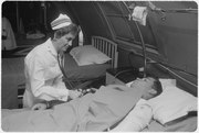 Da Nang, South Vietnam...United States Navy nurse Lieutenant Commander Joan Brouilette checks the condition of Pfc...