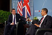 US President Barack Obama and British Prime Minister David Cameron trade bottles of beer to settle a bet they made on the U.S. vs. England World Cup Soccer game (which ended in a tie), during a bilateral meeting at the G20 Summit in Toronto, Canada, Saturday, June 26, 2010