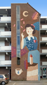 * Nomination Mural in Breda titled "The Chocolate Factory", depicting a "Kwatta girl", a nickname given to the girls who worked there. --ReneeWrites 22:05, 11 July 2023 (UTC) * Promotion Good quality -- Spurzem 10:02, 12 July 2023 (UTC)