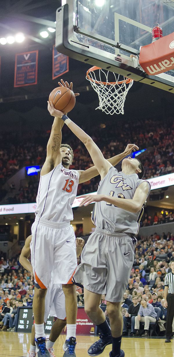 Anthony Gill blocking a shot in 2014, with JPJ interior as backdrop