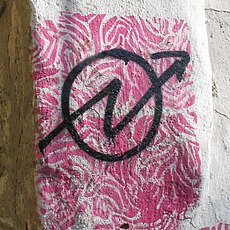 Graffiti con simbolo okupa malaga.jpg