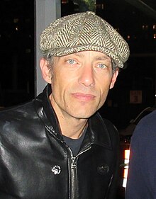 white male wearing his leather jacket with smiles at the camera
