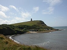 View  southeast at Kimmeridge Bay with Clavell Tower in the background